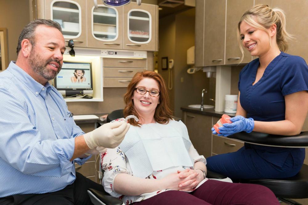 Dr. Clark holding aligner with patient, scottsdale az