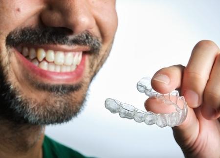 Man holding invisalign aligner, scottsdale az