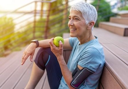 Older woman eating an apple outside, scottsdale az