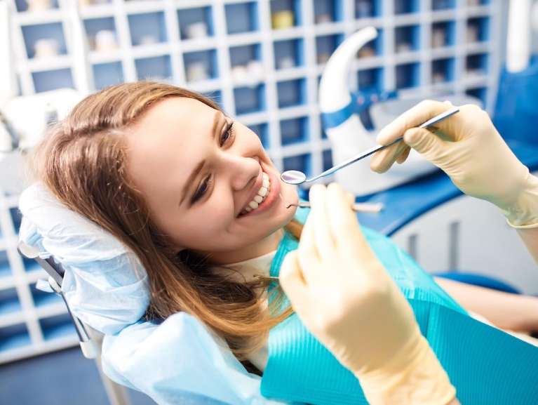 woman getting her teeth cleaned in scottsdale