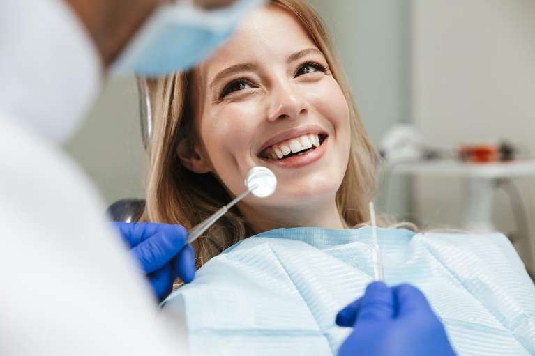 Women smiling with red hair in dentist chair, scottsdale az