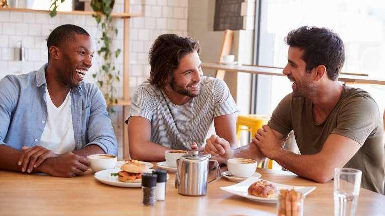 Young men smiling around a table, scottsdale az