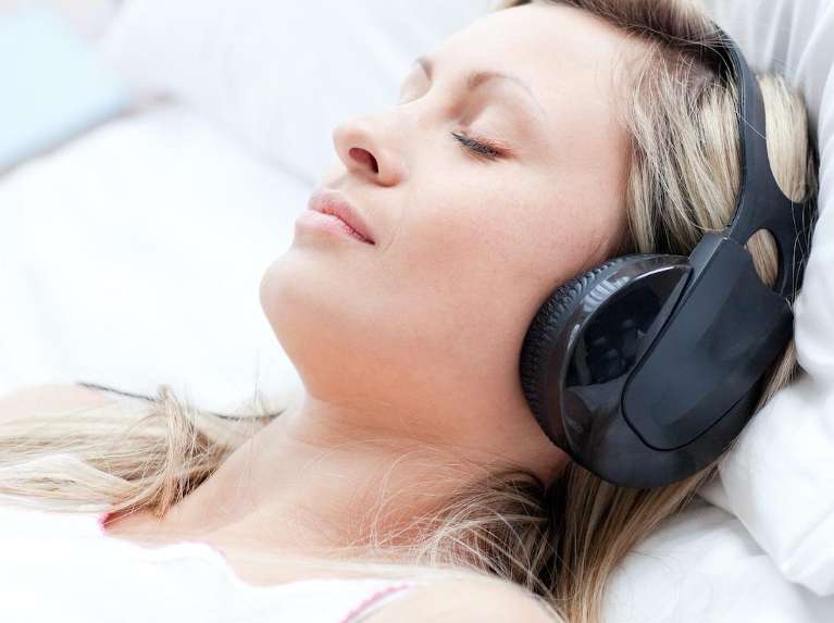 Woman using noise-canceling headphones, scottsdale az